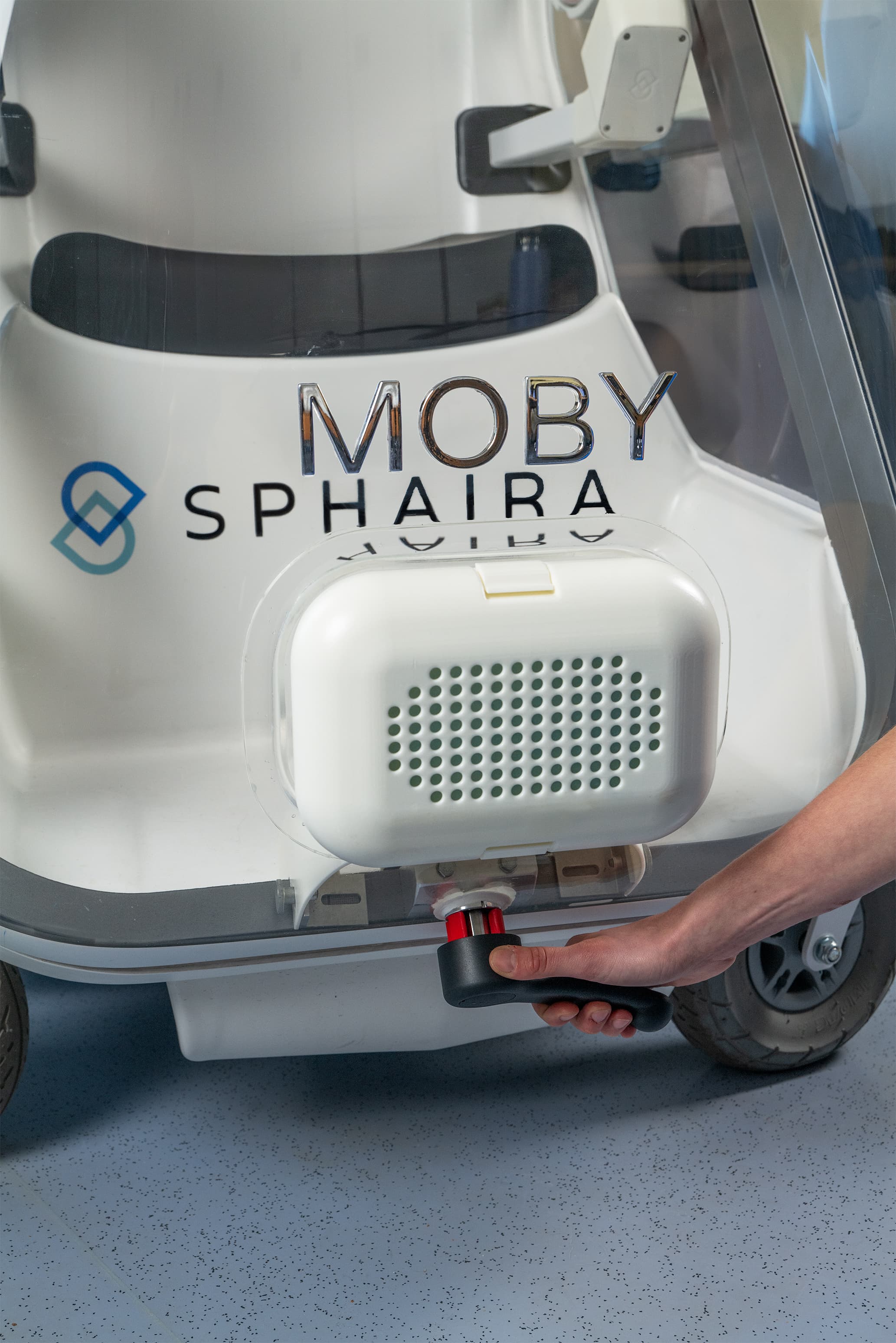 The MOBY filter unit with its grille, a hand on the handle below